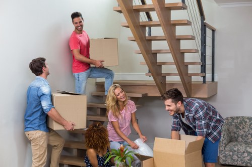 Professional packing team handling boxes in storage facility